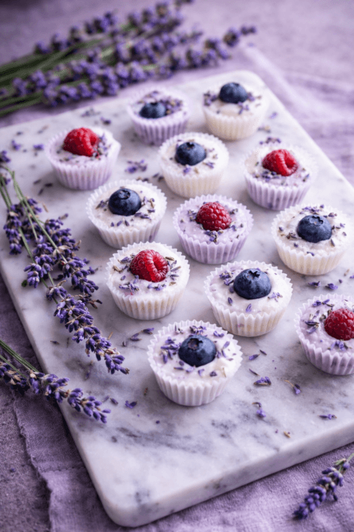 lavender honey frozen yogurt bites with berries on marble board